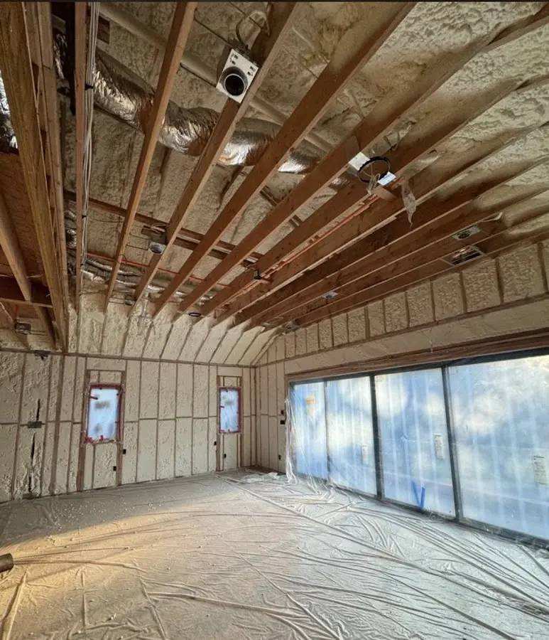 Interior walls and ceiling insulated with spray foam during new construction in Syracuse